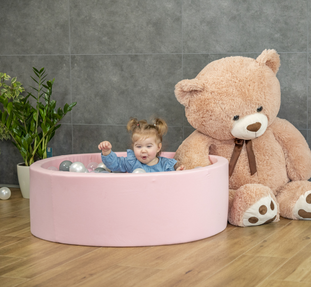 A little girl in the ball pit