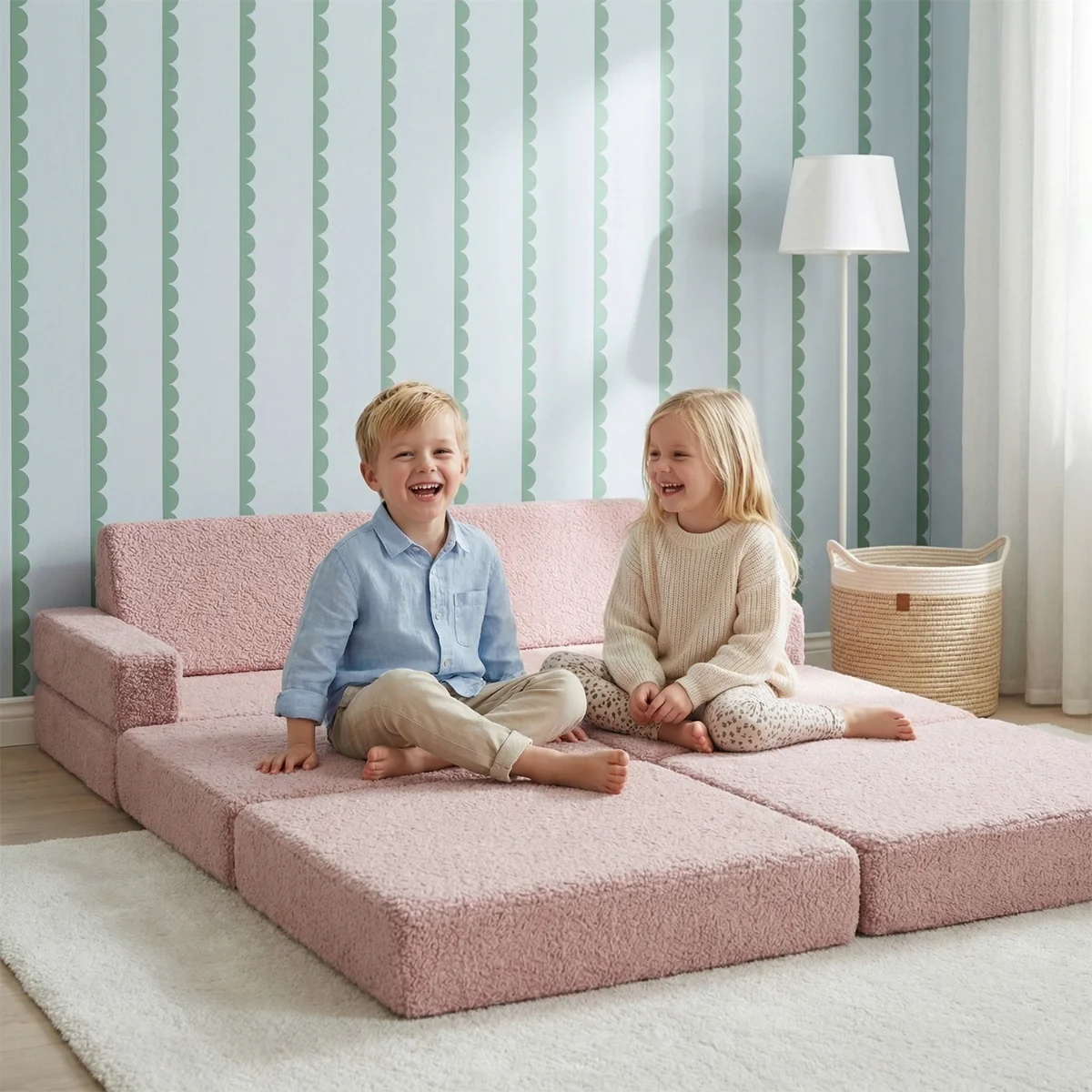 Children playing on a pink teddy mattress unfolded on the floor
