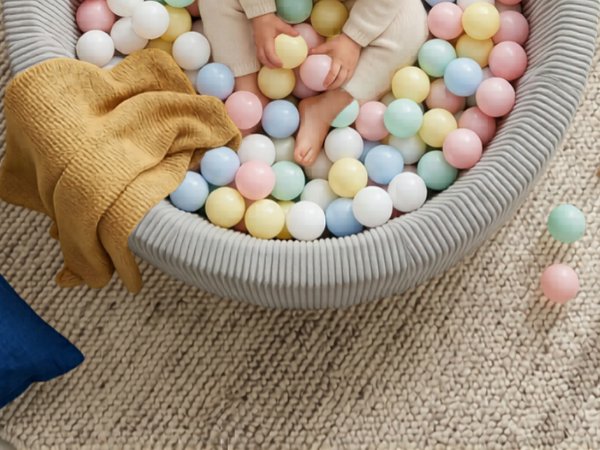 Beige fabric ball pit with colorful pastel foam balls in